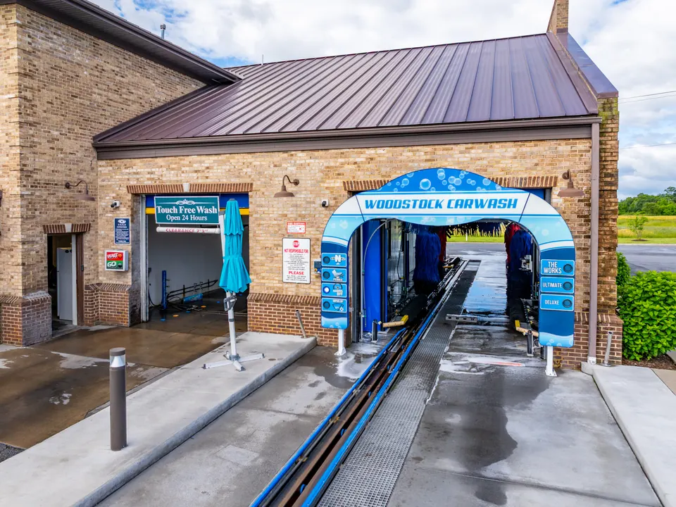 Car going through the express wash tunnel at Woodstock Car Wash